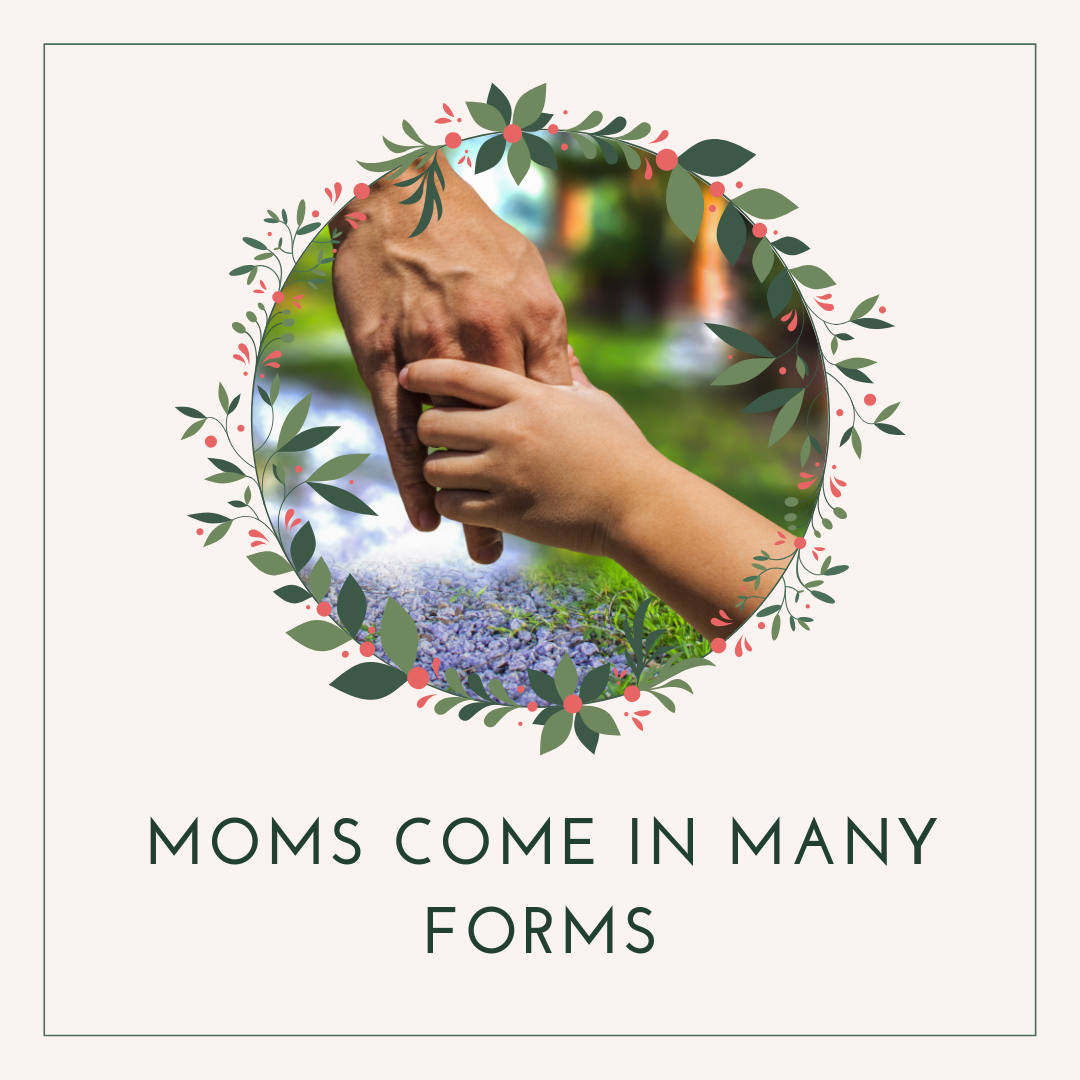 mother's hand and child's hand linked with a garden in the background. 